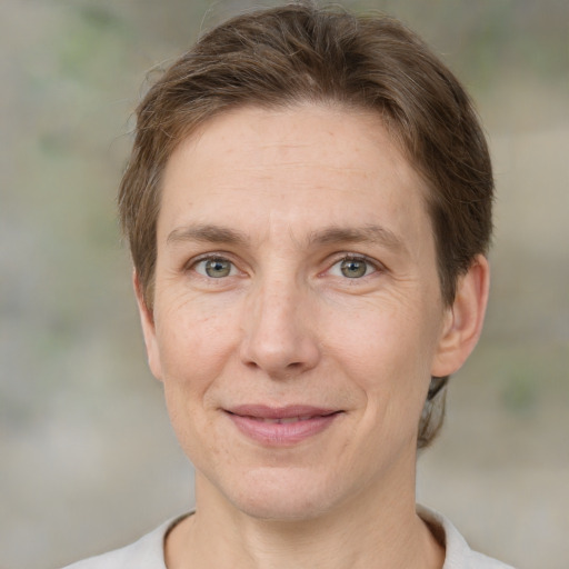 Joyful white adult female with short  brown hair and brown eyes