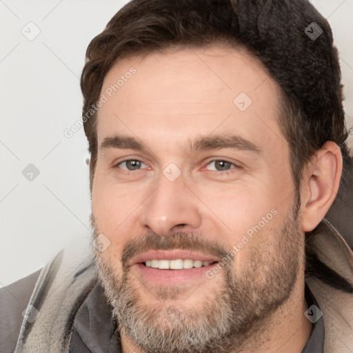 Joyful white adult male with short  brown hair and brown eyes