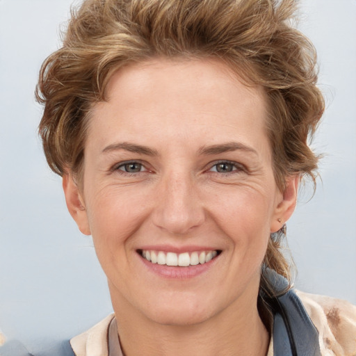 Joyful white adult female with short  brown hair and brown eyes