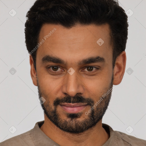 Joyful latino young-adult male with short  black hair and brown eyes