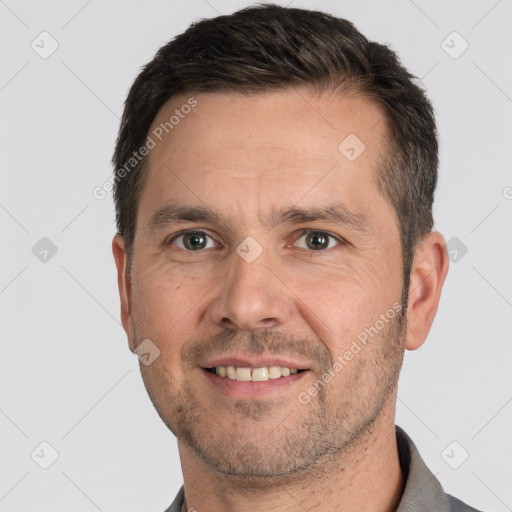 Joyful white adult male with short  brown hair and brown eyes