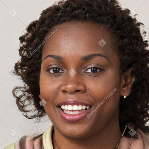 Joyful black young-adult female with long  brown hair and brown eyes