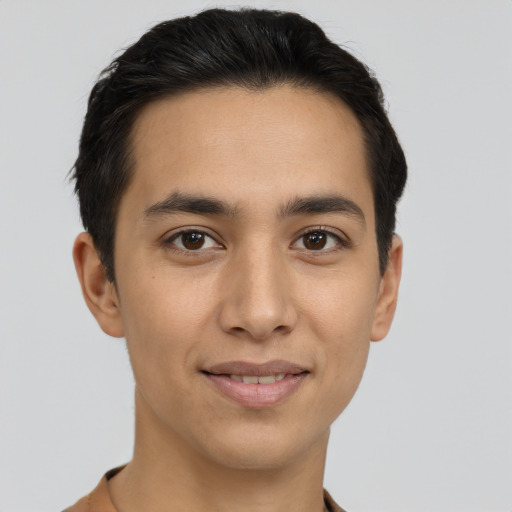 Joyful latino young-adult male with short  brown hair and brown eyes