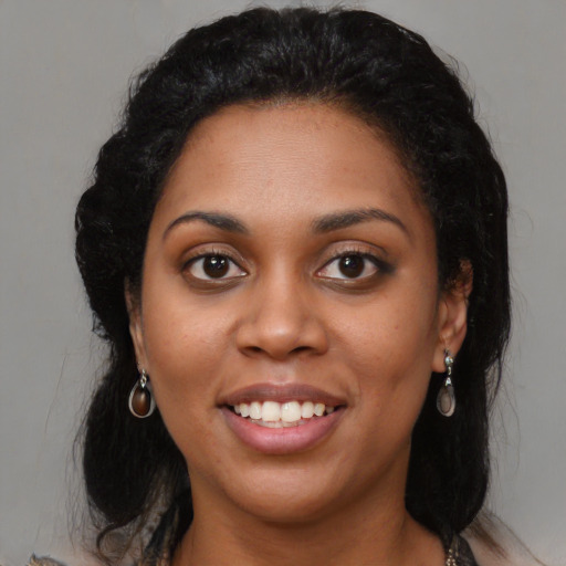 Joyful latino young-adult female with medium  black hair and brown eyes