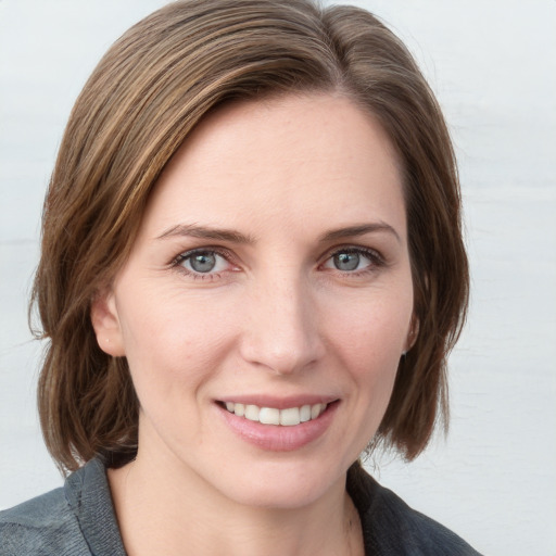 Joyful white young-adult female with medium  brown hair and blue eyes