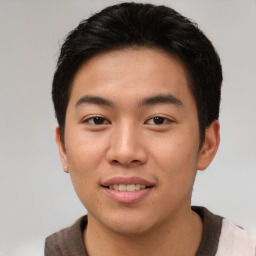 Joyful asian young-adult male with short  brown hair and brown eyes