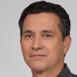 Joyful white adult male with short  black hair and brown eyes