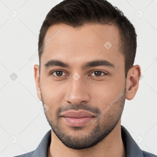 Joyful white young-adult male with short  brown hair and brown eyes