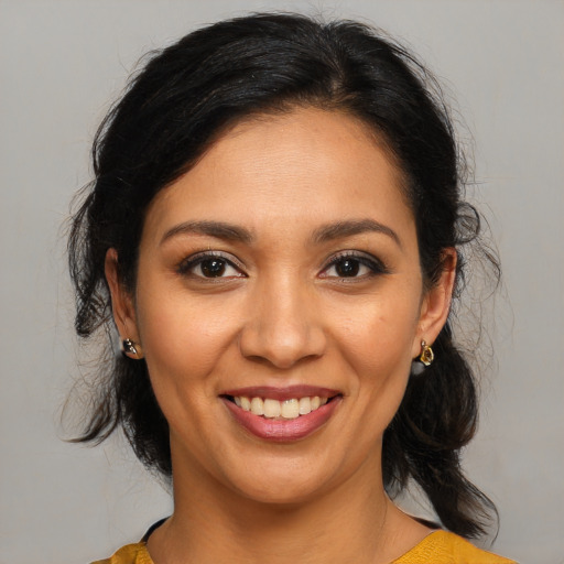 Joyful latino young-adult female with medium  brown hair and brown eyes