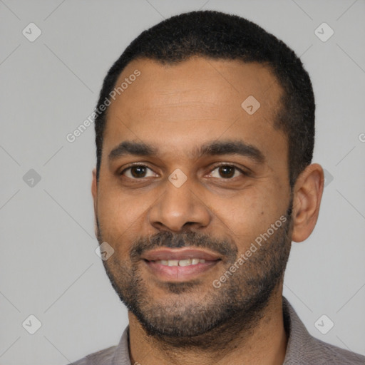 Joyful latino young-adult male with short  black hair and brown eyes