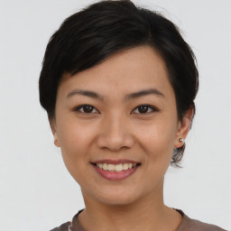 Joyful asian young-adult female with short  brown hair and brown eyes