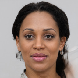 Joyful black young-adult female with medium  brown hair and brown eyes