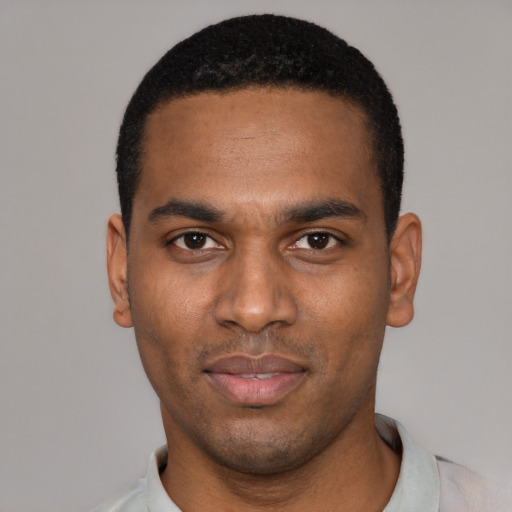 Joyful black young-adult male with short  black hair and brown eyes