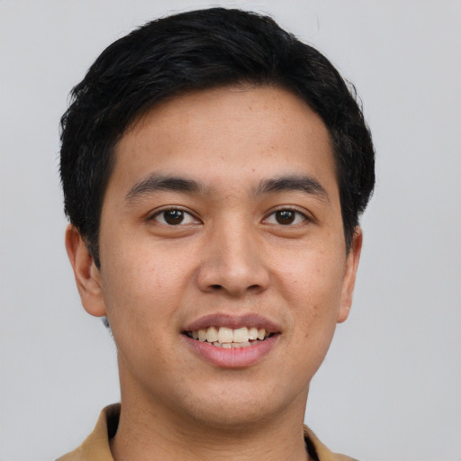 Joyful asian young-adult male with short  brown hair and brown eyes
