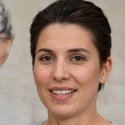 Joyful white adult female with short  brown hair and brown eyes