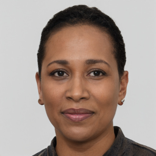 Joyful black adult female with short  black hair and brown eyes