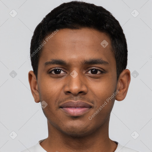 Joyful black young-adult male with short  black hair and brown eyes