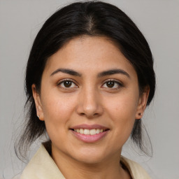 Joyful latino young-adult female with medium  brown hair and brown eyes