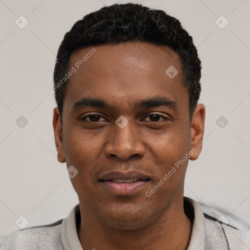 Joyful black young-adult male with short  black hair and brown eyes