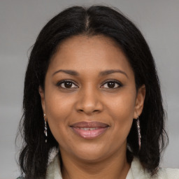 Joyful black young-adult female with medium  brown hair and brown eyes