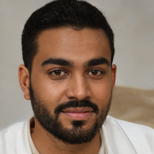 Joyful black young-adult male with short  black hair and brown eyes