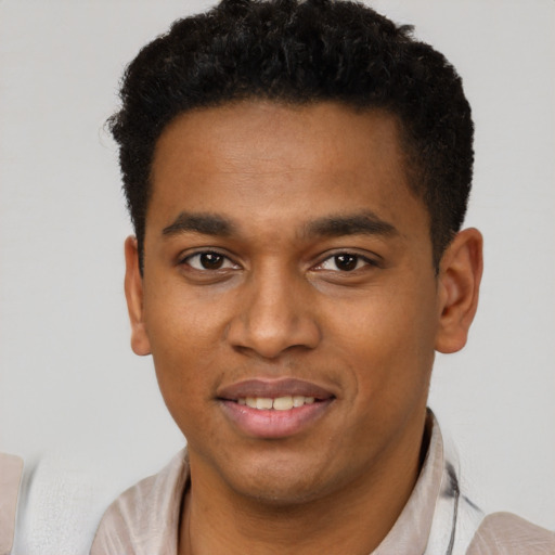 Joyful latino young-adult male with short  brown hair and brown eyes