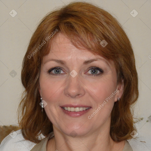 Joyful white adult female with medium  brown hair and blue eyes