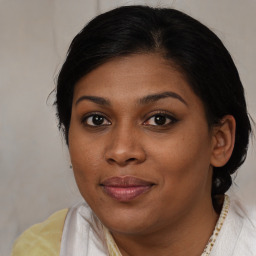 Joyful black young-adult female with medium  brown hair and brown eyes