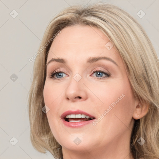 Joyful white young-adult female with medium  brown hair and blue eyes