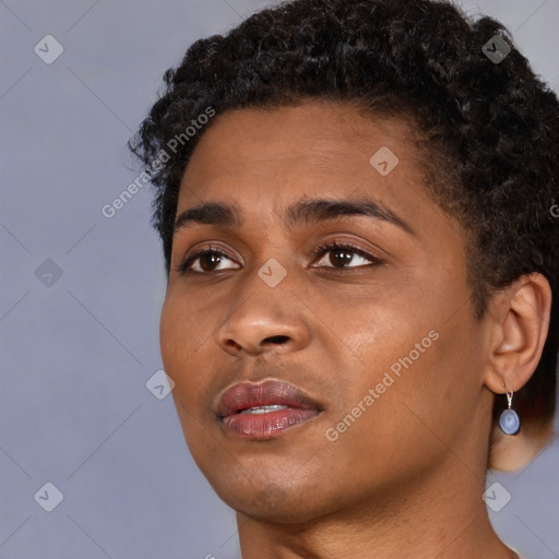 Joyful black young-adult female with short  black hair and brown eyes