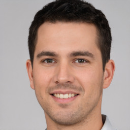 Joyful white young-adult male with short  brown hair and brown eyes