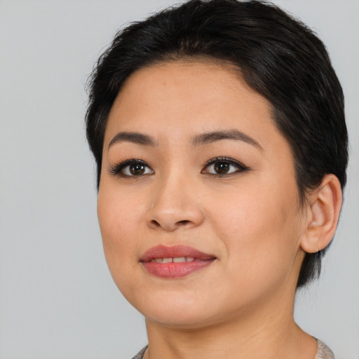 Joyful asian young-adult female with medium  black hair and brown eyes