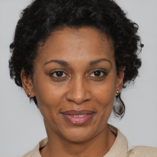 Joyful black adult female with short  brown hair and brown eyes