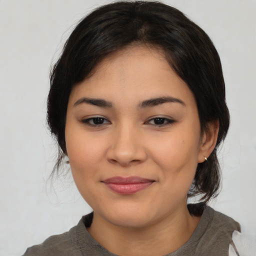 Joyful latino young-adult female with medium  black hair and brown eyes