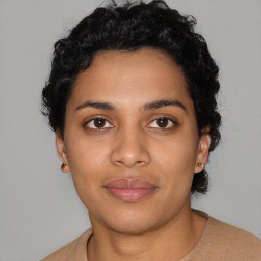 Joyful latino young-adult female with short  black hair and brown eyes