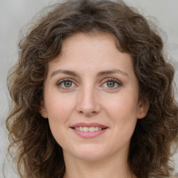 Joyful white young-adult female with long  brown hair and green eyes