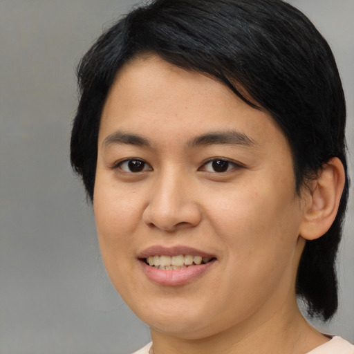 Joyful asian young-adult female with medium  black hair and brown eyes