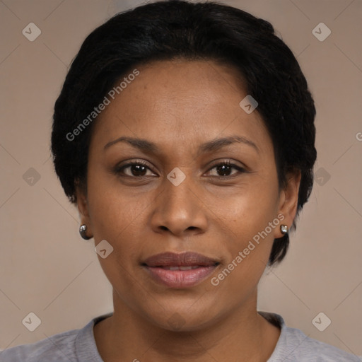 Joyful black adult female with short  black hair and brown eyes