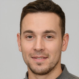 Joyful white young-adult male with short  brown hair and brown eyes