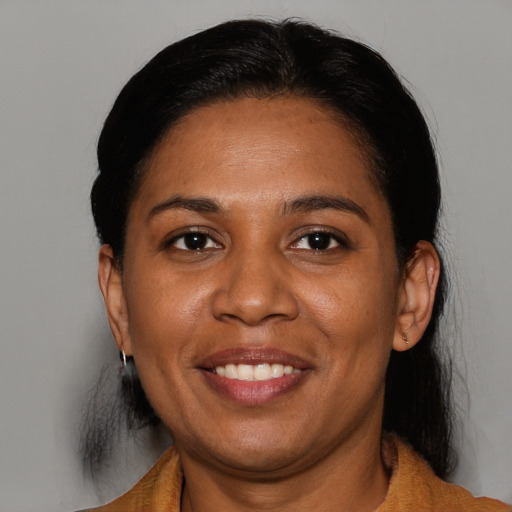 Joyful black adult female with medium  brown hair and brown eyes