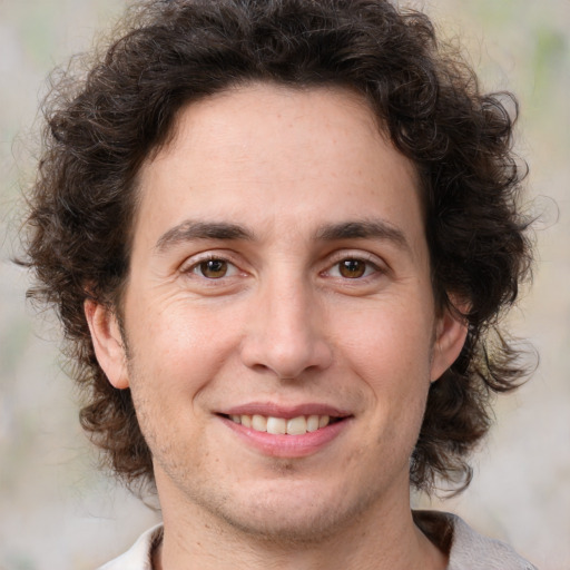 Joyful white adult male with medium  brown hair and brown eyes