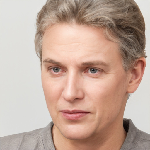 Joyful white adult male with short  brown hair and grey eyes