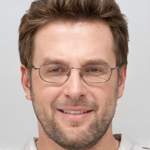 Joyful white adult male with short  brown hair and grey eyes