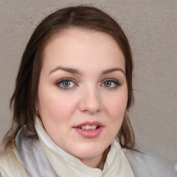 Joyful white young-adult female with medium  brown hair and blue eyes