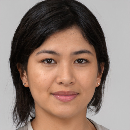 Joyful asian young-adult female with medium  black hair and brown eyes