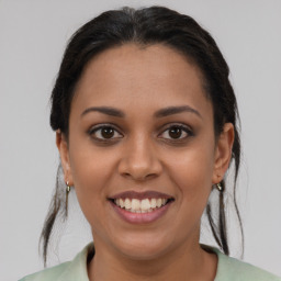 Joyful latino young-adult female with medium  brown hair and brown eyes