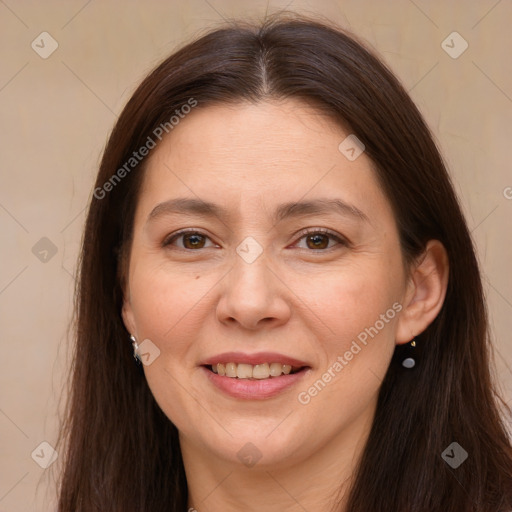 Joyful white adult female with long  brown hair and brown eyes