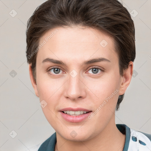 Joyful white young-adult female with short  brown hair and grey eyes