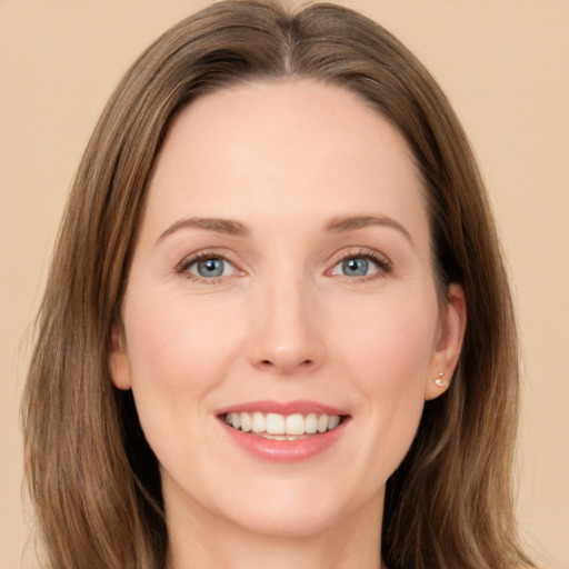 Joyful white young-adult female with long  brown hair and grey eyes