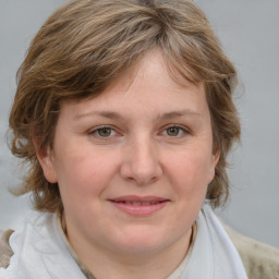 Joyful white young-adult female with medium  brown hair and blue eyes